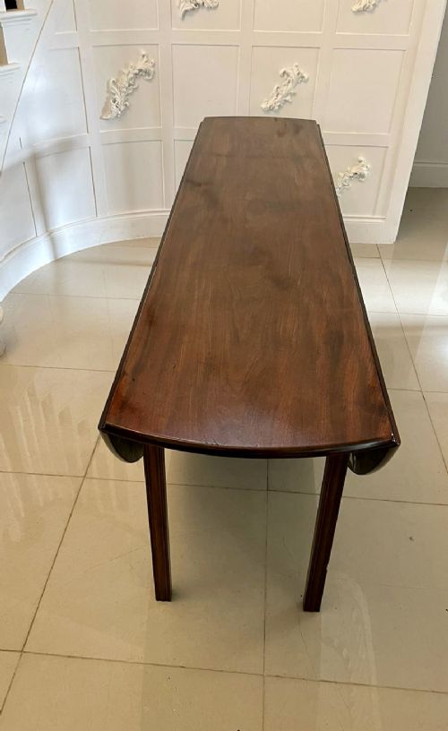 A large Georgian mahogany wake table shown with drop leaves folded down, featuring straight square legs and a polished polished timber top. View XI