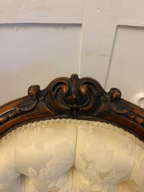 fig 4. A Victorian carved walnut slipper chair featuring a button-tufted cream damask spoon-shaped backrest and cabriole front legs.