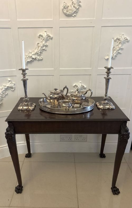 fig 3. A George III mahogany centre table featuring a rectangular flat top, deep apron, and four carved legs ending in claw and ball feet.