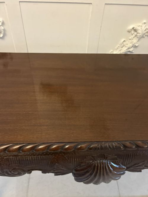 fig 1. A Victorian carved mahogany console table featuring cabriole legs with ball and claw feet, a shell-carved central apron, and a gadrooned top border.