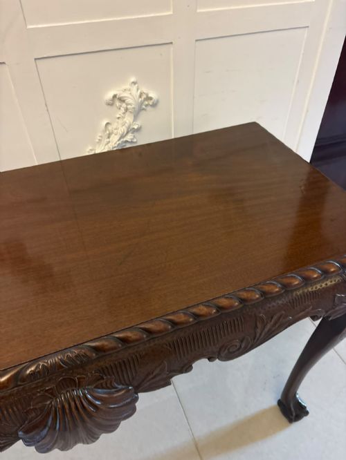 fig 2. A Victorian carved mahogany console table featuring cabriole legs with ball and claw feet, a shell-carved central apron, and a gadrooned top border.