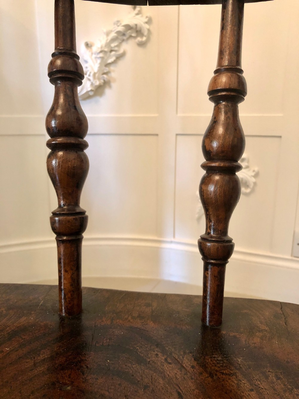 An antique dark oak captains desk chair featuring a curved crest rail, turned spindles, a contoured saddle seat, and sturdy turned legs. View IX