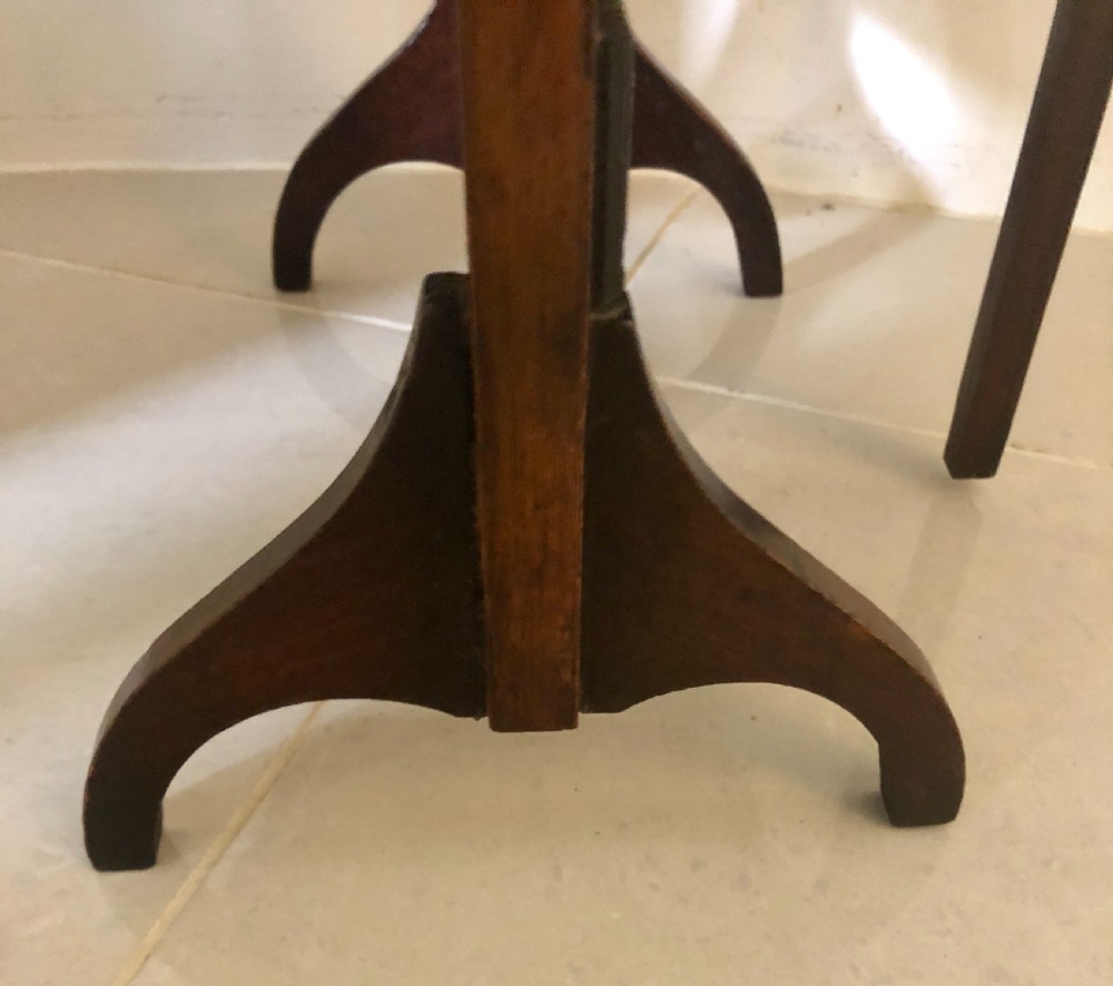 An antique three-tier walnut folding cake stand featuring shaped moulded trays, a curved top carrying handle, and straight wooden side supports. View VIII