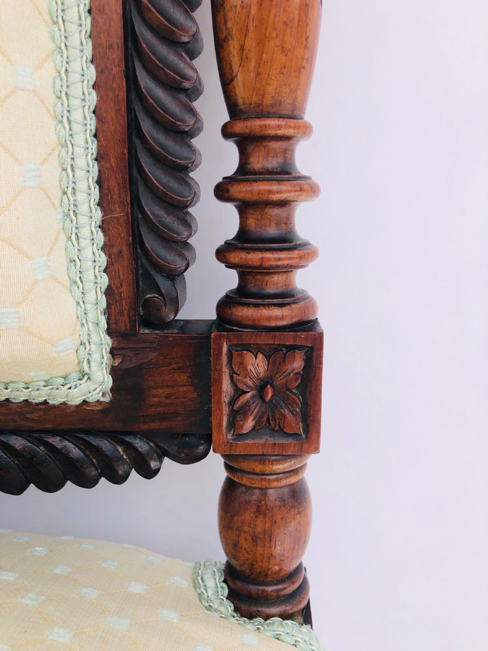 A Victorian carved rosewood side chair featuring a high back with ornate carved cresting, turned side columns, and light cream pattern upholstered seating. View III