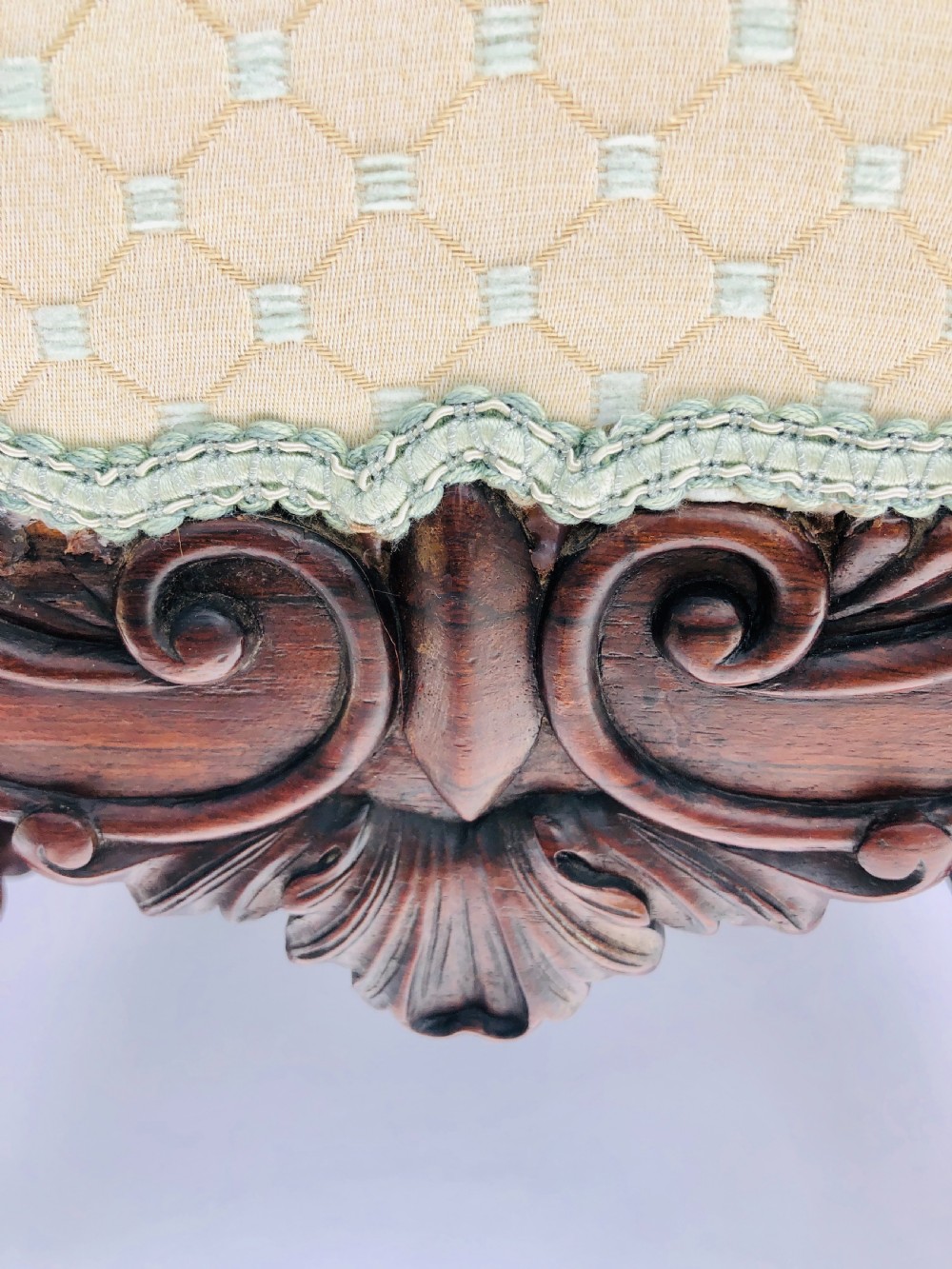 A Victorian carved rosewood side chair featuring a high back with ornate carved cresting, turned side columns, and light cream pattern upholstered seating. View VII