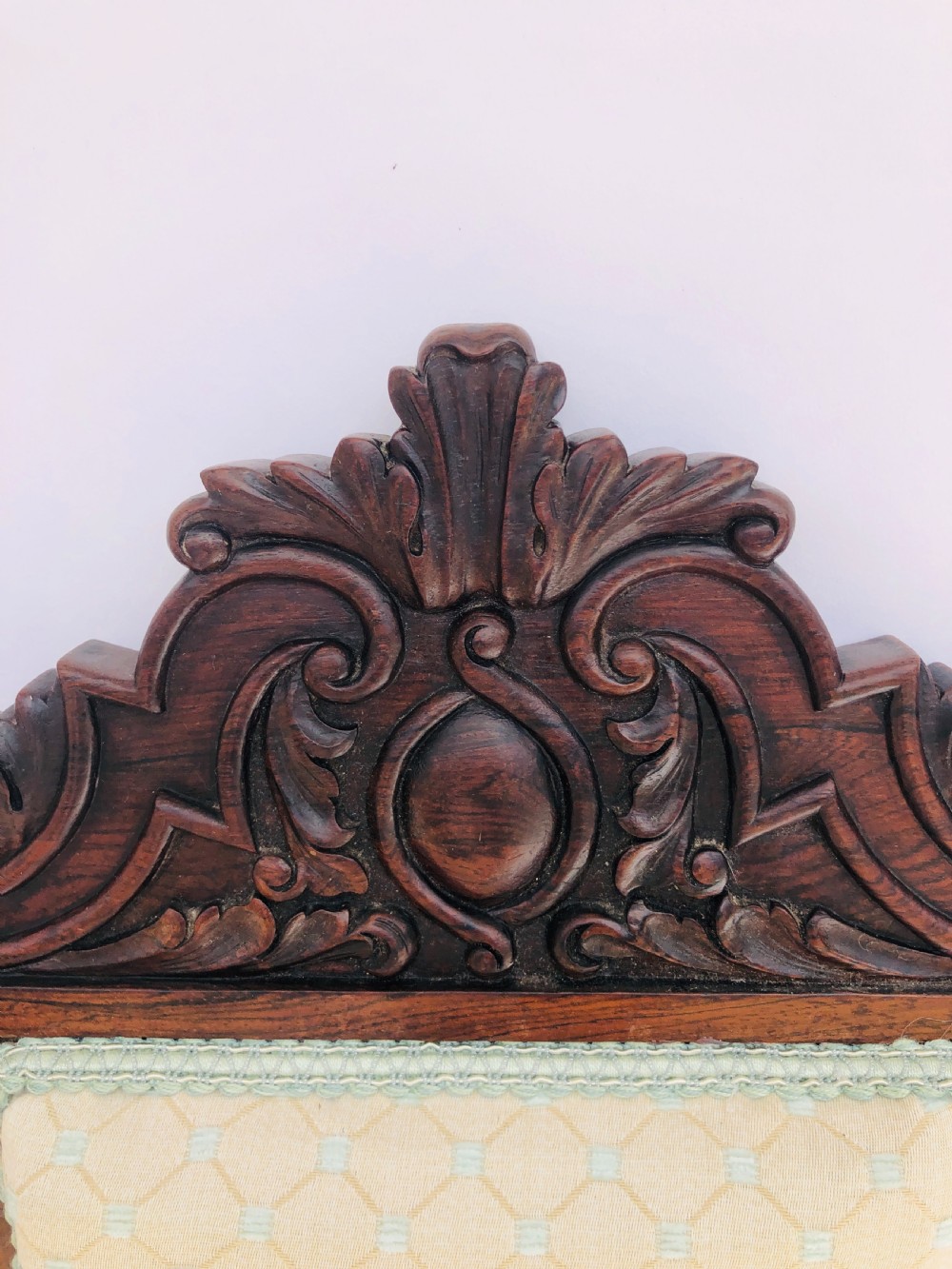 A Victorian carved rosewood side chair featuring a high back with ornate carved cresting, turned side columns, and light cream pattern upholstered seating. View VIII