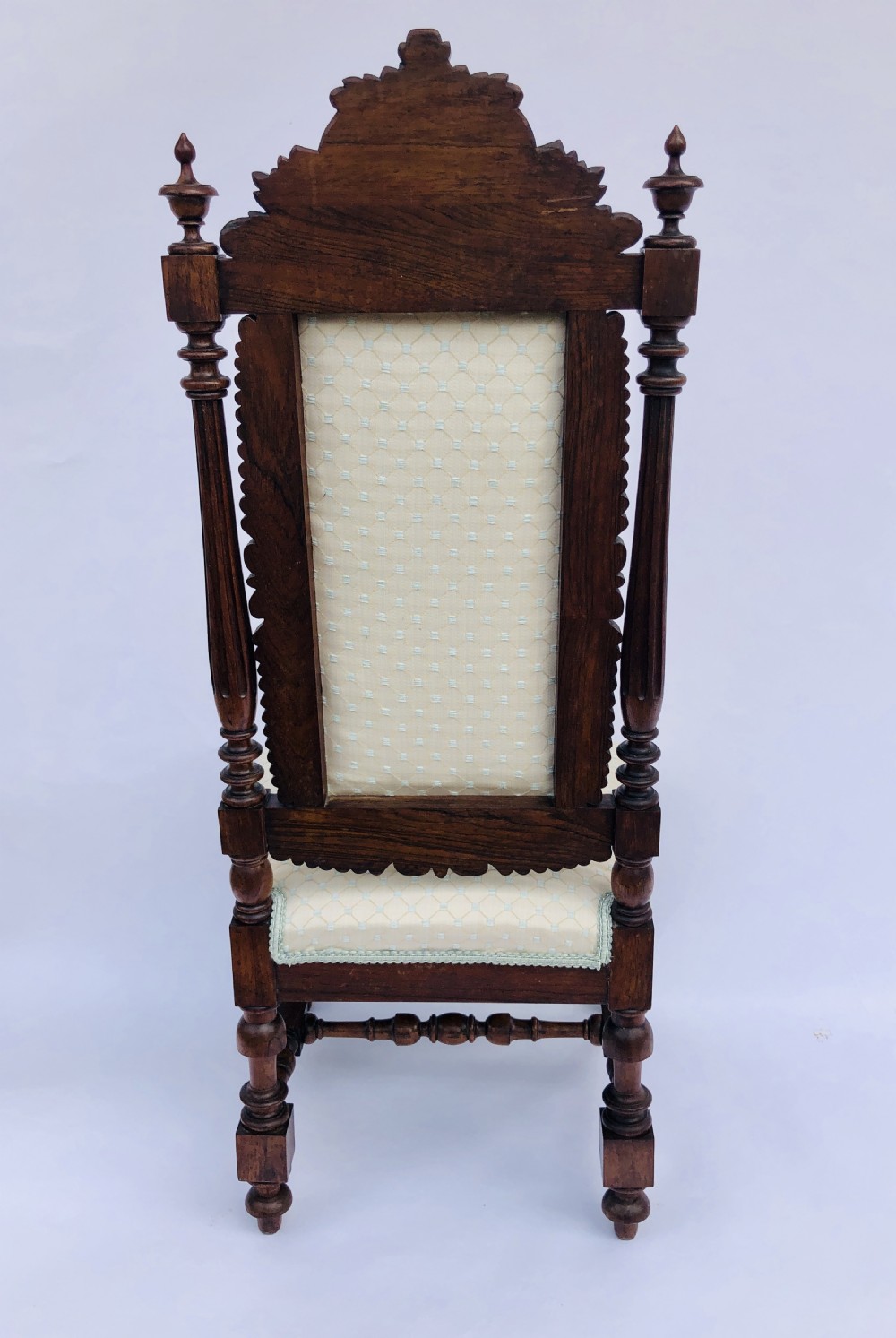 A Victorian carved rosewood side chair featuring a high back with ornate carved cresting, turned side columns, and light cream pattern upholstered seating. View XI