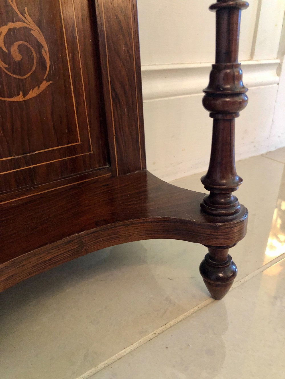 An Edwardian rosewood overmantel mirror featuring detailed bow and urn marquetry inlays, turned supporting columns, and a central rectangular glass plate. View III