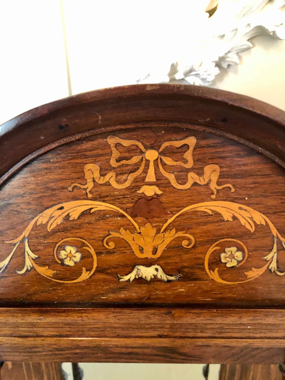 An Edwardian rosewood overmantel mirror featuring detailed bow and urn marquetry inlays, turned supporting columns, and a central rectangular glass plate. View VIII