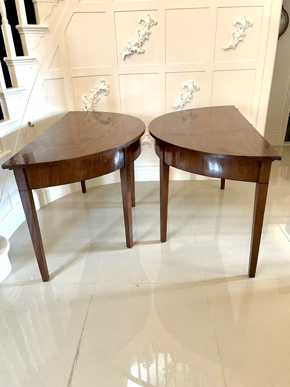 Pair of George III mahogany demi lune console tables 