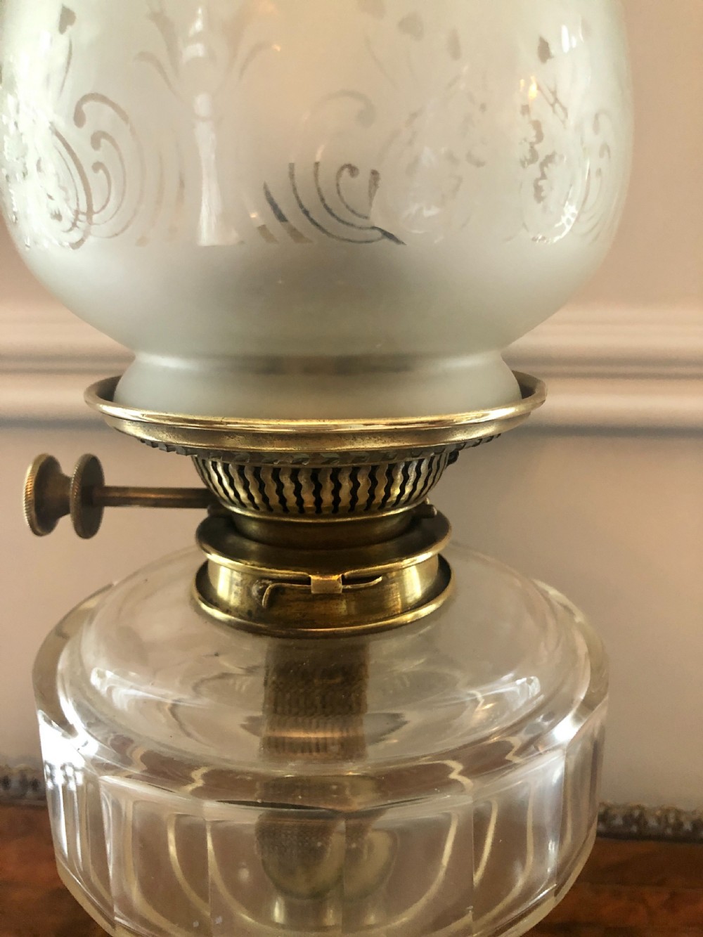 A Victorian oil lamp featuring a weighted brass base, clear glass reservoir, etched glass shade with a green crimped rim, and a tall clear glass chimney. View III
