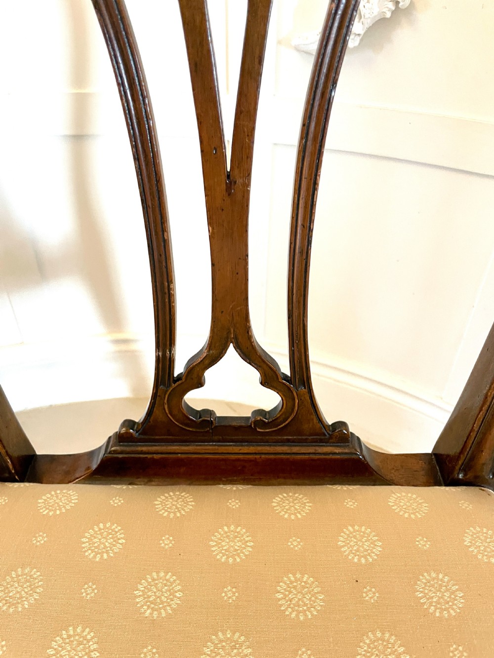 A set of four 19th-century mahogany dining chairs with carved openwork backrests and cream patterned upholstered seats. View II