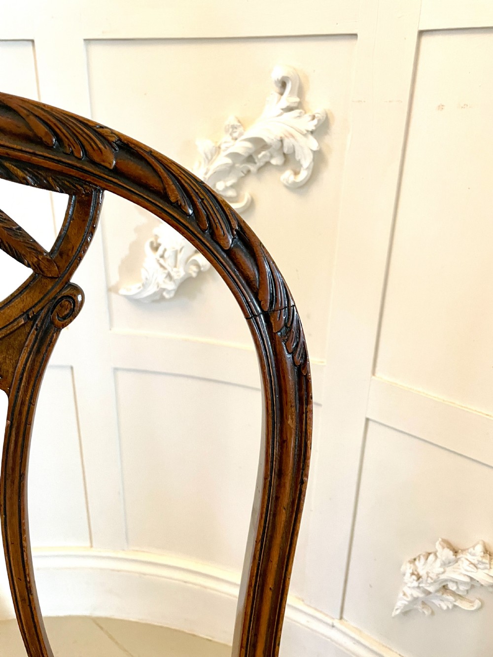 A set of four 19th-century mahogany dining chairs with carved openwork backrests and cream patterned upholstered seats. View III