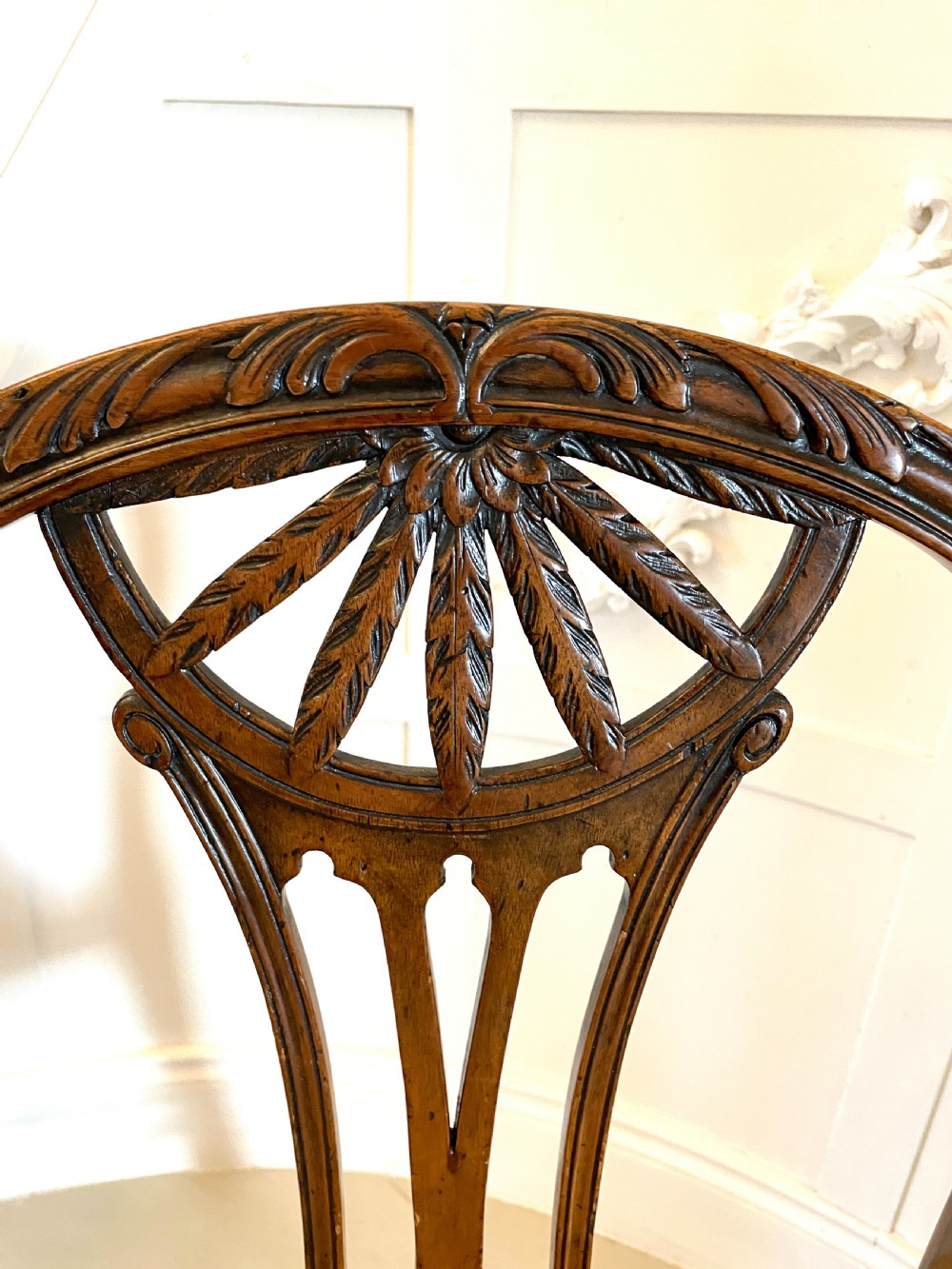A set of four 19th-century mahogany dining chairs with carved openwork backrests and cream patterned upholstered seats. View V