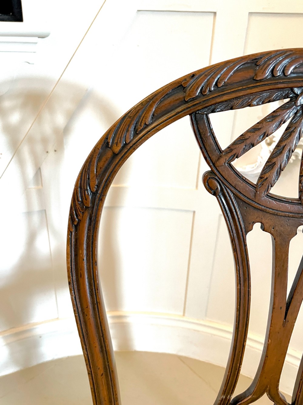 A set of four 19th-century mahogany dining chairs with carved openwork backrests and cream patterned upholstered seats. View VI