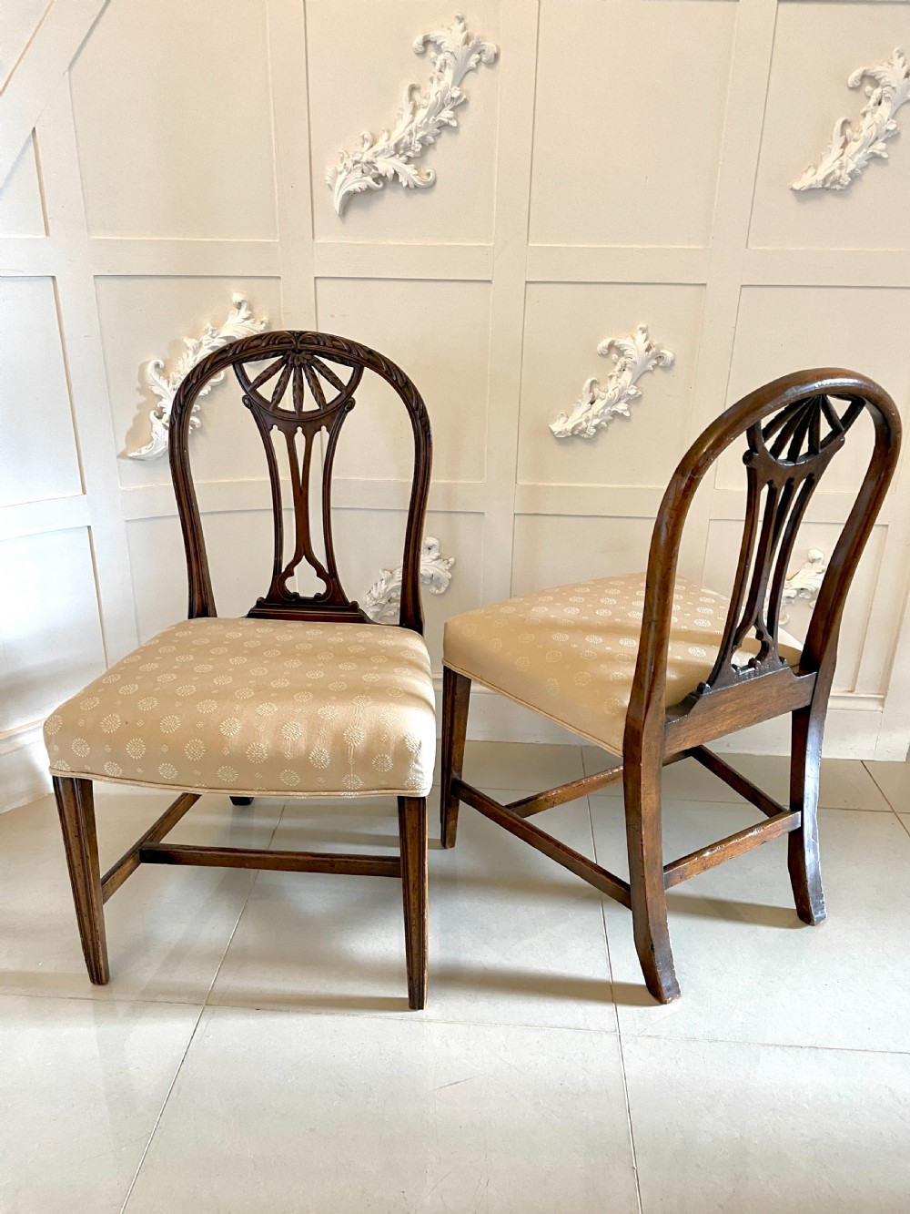 A set of four 19th-century mahogany dining chairs with carved openwork backrests and cream patterned upholstered seats. View VII