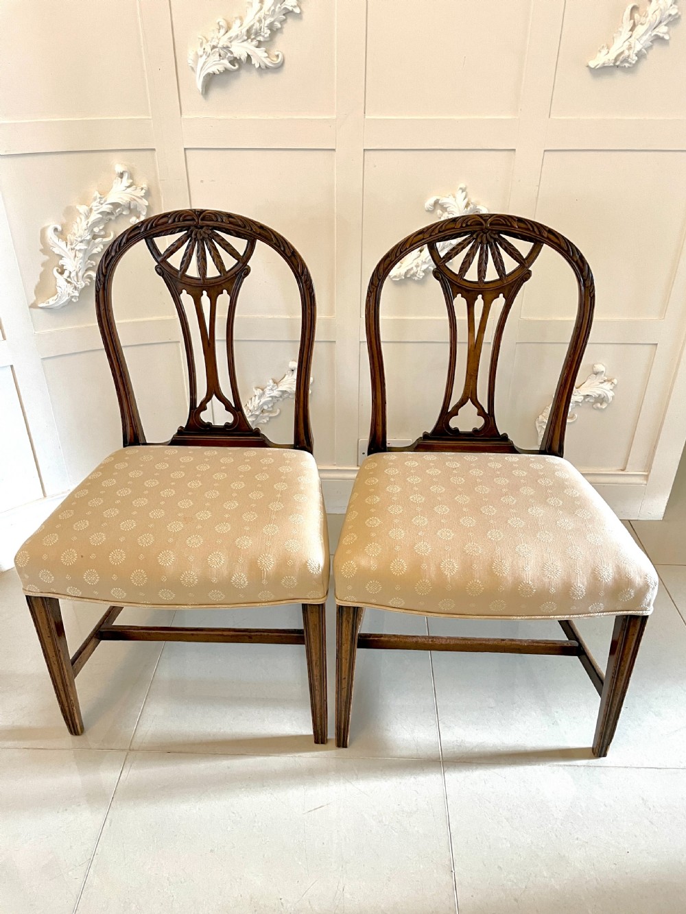 A set of four 19th-century mahogany dining chairs with carved openwork backrests and cream patterned upholstered seats. View VIII