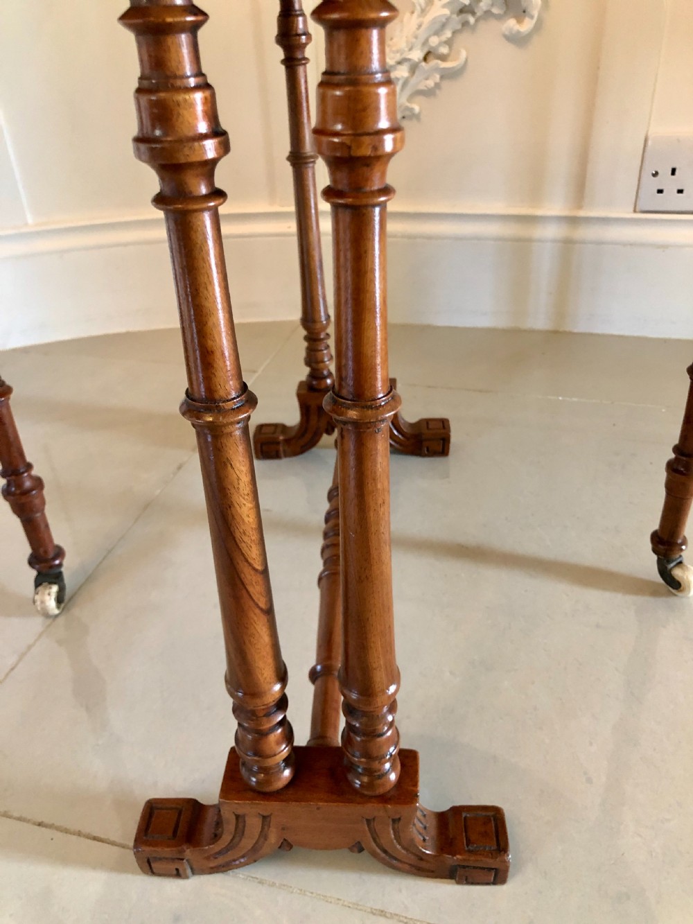 A Victorian walnut Sutherland table with drop leaves folded down, set on turned legs and ceramic castors. View VIII