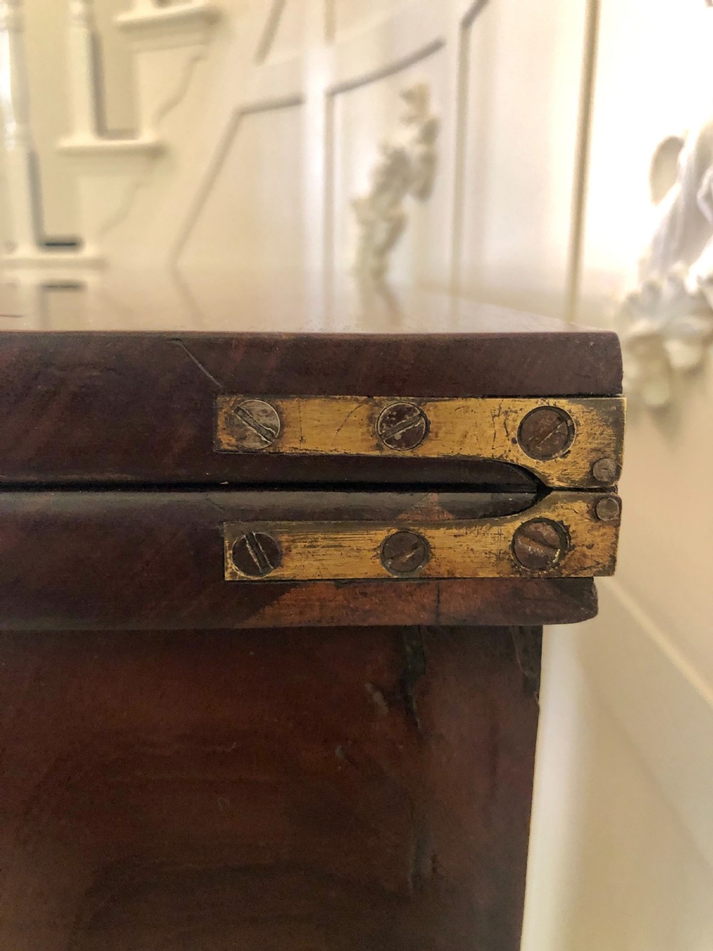 A William IV mahogany fold-over tea table featuring a rectangular swivel top on a square pedestal and a quadruped base with scrolled feet. View VIII