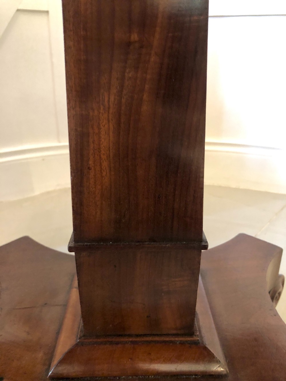 A William IV mahogany fold-over tea table featuring a rectangular swivel top on a square pedestal and a quadruped base with scrolled feet. View XI
