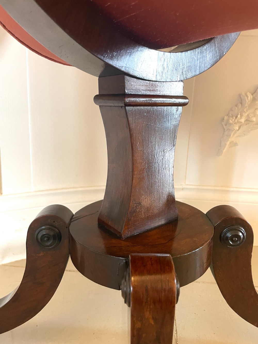 An antique Regency rosewood sewing table featuring small drop leaves, drawers with brass handles, a terracotta fabric work basket below, and a pedestal base with four splayed legs on castors. View VIII