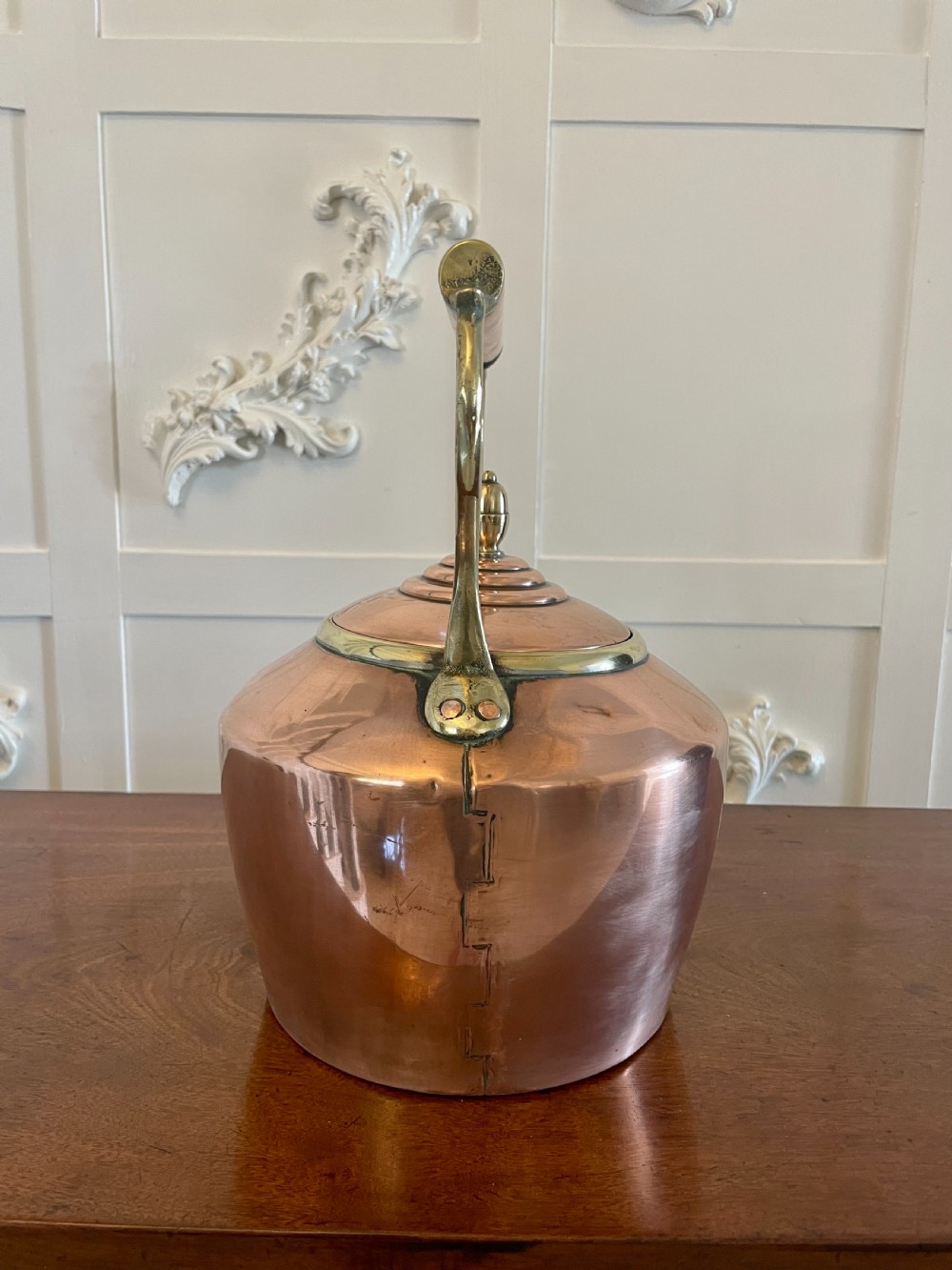 A George III copper tea kettle featuring a brass-accented overhead handle, a gooseneck spout, and a stepped lid with a brass finial. View IX
