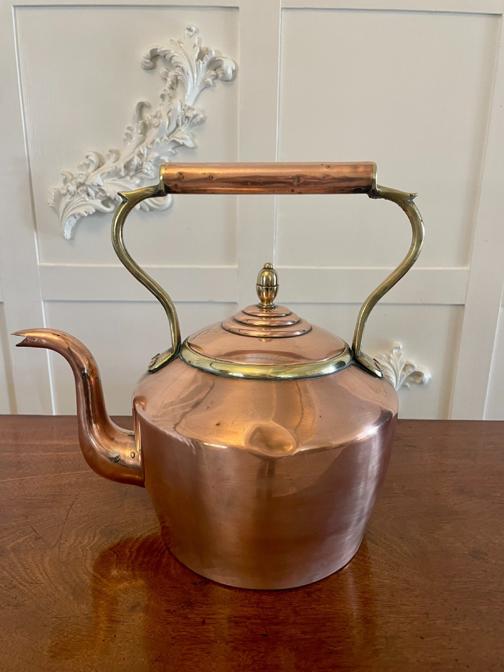 A George III copper tea kettle featuring a brass-accented overhead handle, a gooseneck spout, and a stepped lid with a brass finial. View XI