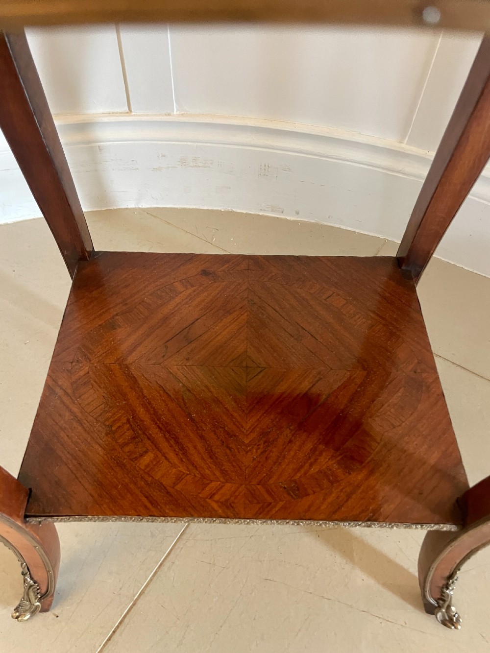 A French-style kingwood lamp table featuring geometric parquetry veneer, gilt-bronze ormolu mounts on cabriole legs, a pierced brass gallery rail, and an undertier shelf. View II