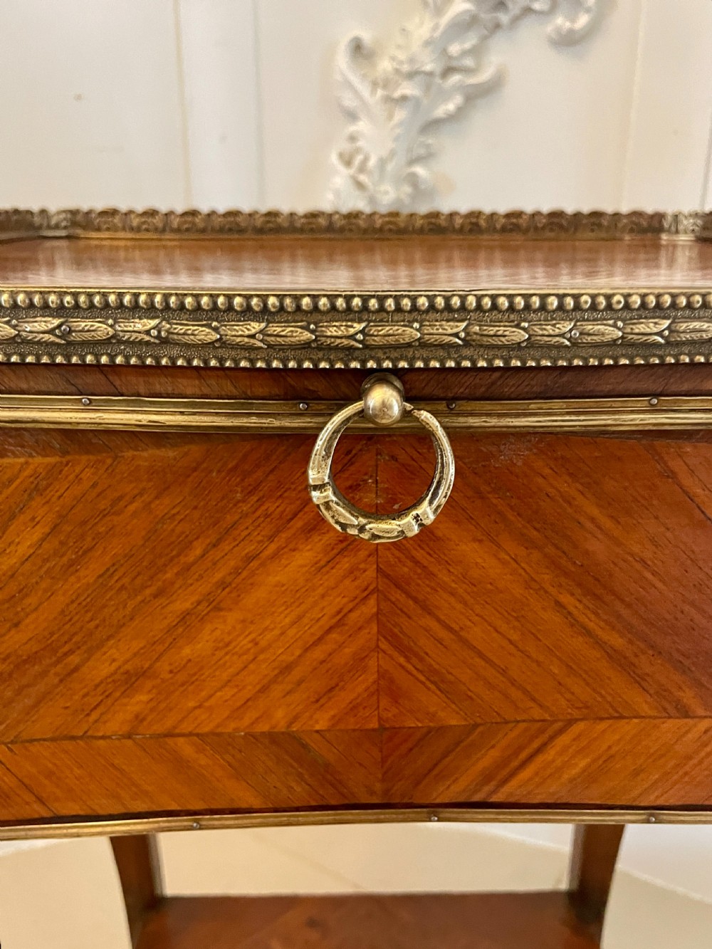 A French-style kingwood lamp table featuring geometric parquetry veneer, gilt-bronze ormolu mounts on cabriole legs, a pierced brass gallery rail, and an undertier shelf. View VII