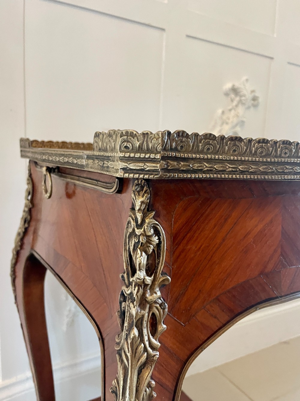 A French-style kingwood lamp table featuring geometric parquetry veneer, gilt-bronze ormolu mounts on cabriole legs, a pierced brass gallery rail, and an undertier shelf. View VIII