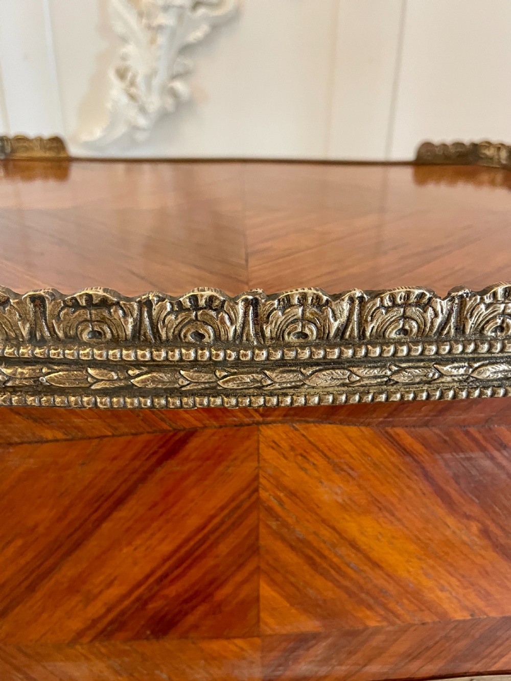 A French-style kingwood lamp table featuring geometric parquetry veneer, gilt-bronze ormolu mounts on cabriole legs, a pierced brass gallery rail, and an undertier shelf. View X