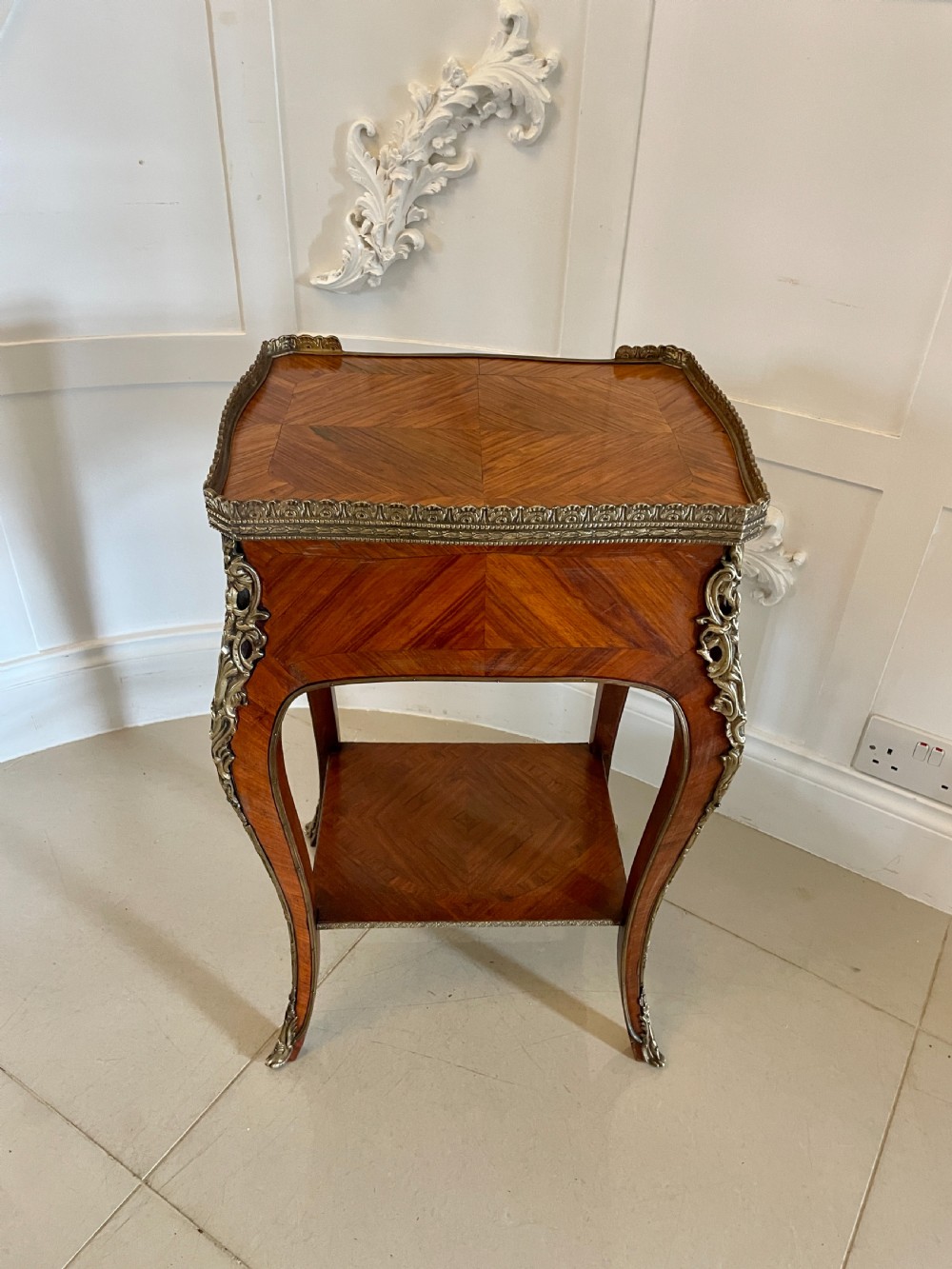 A French-style kingwood lamp table featuring geometric parquetry veneer, gilt-bronze ormolu mounts on cabriole legs, a pierced brass gallery rail, and an undertier shelf. View XI