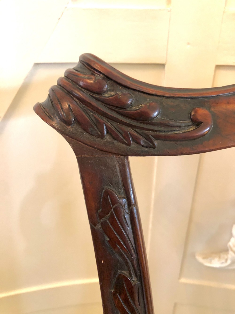 A carved mahogany Chippendale style desk armchair featuring a pierced back splat, scrolled armrests, light upholstered seat, and cabriole legs ending in ball and claw feet. View XII