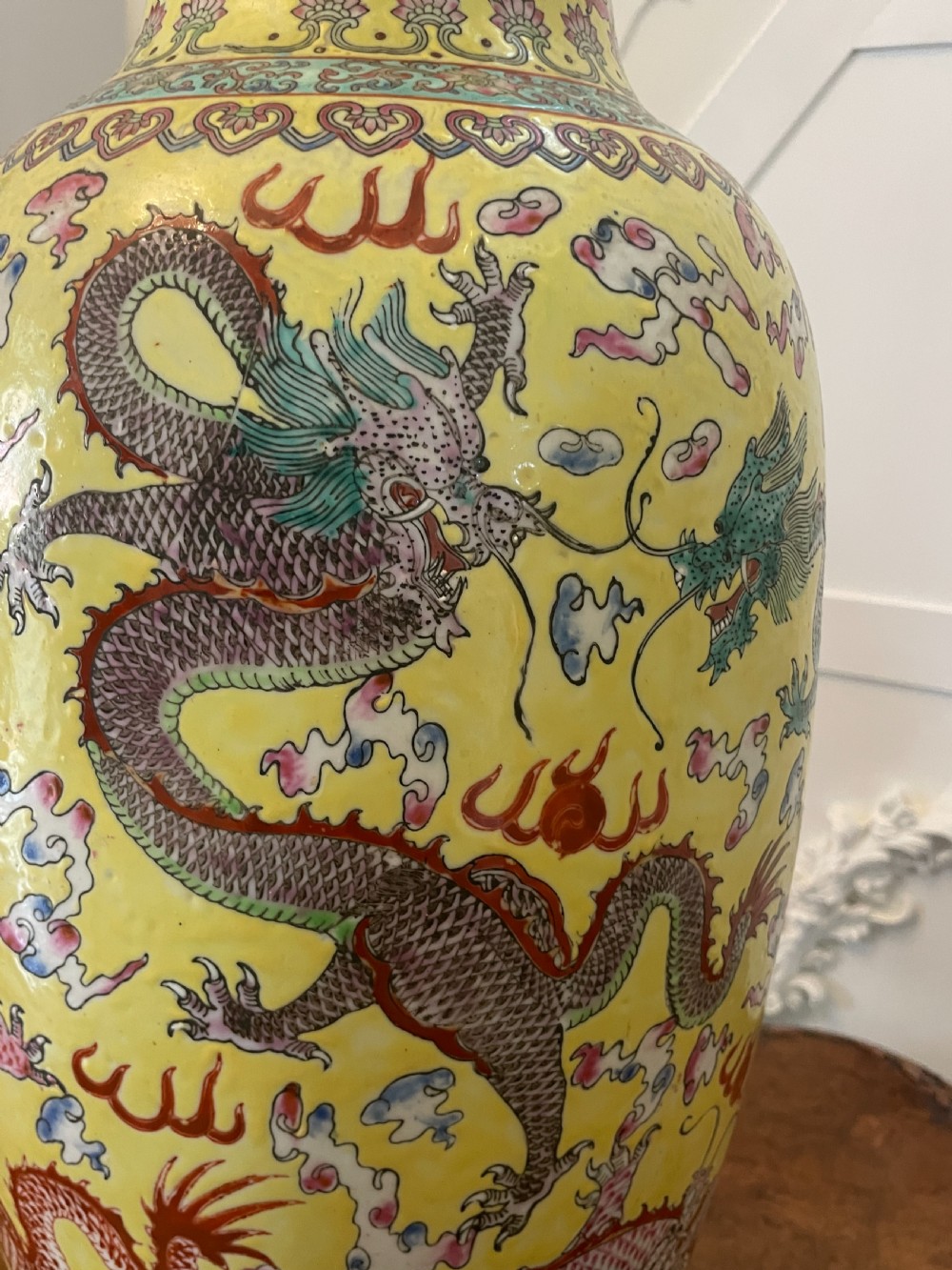 A pair of large nineteenth-century Chinese yellow porcelain vase lamps decorated with hand-painted multicoloured dragons and mounted on carved dark wooden bases. View XIII