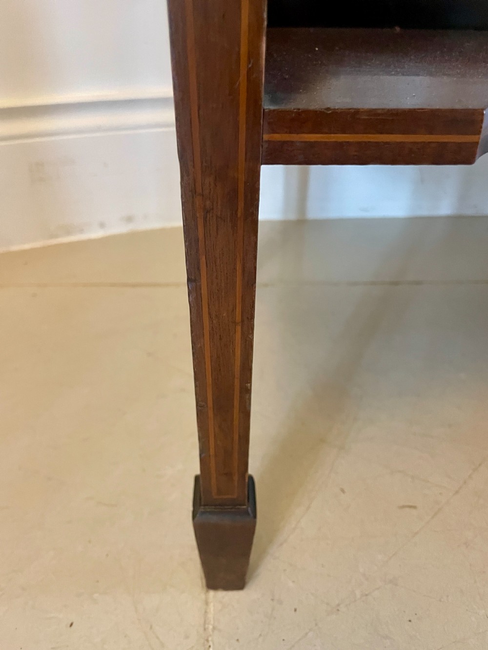 An Edwardian inlaid mahogany display cabinet featuring glazed doors with astragal bars, a central marquetry medallion, interior shelves, and a bottom undertier. View III