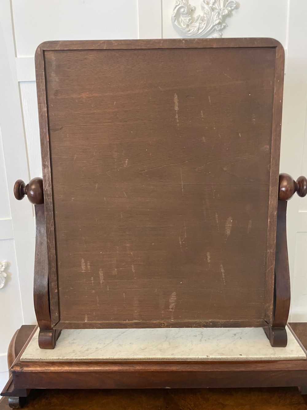 Victorian mahogany swing mirror featuring a rectangular frame set between carved scroll uprights above a white marble inset base. View III