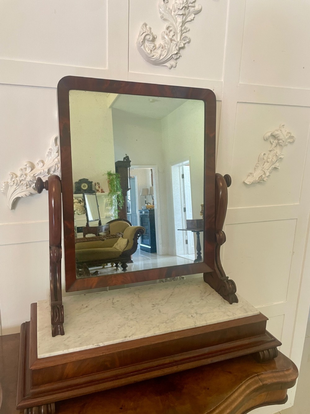 Victorian mahogany swing mirror featuring a rectangular frame set between carved scroll uprights above a white marble inset base. View XII