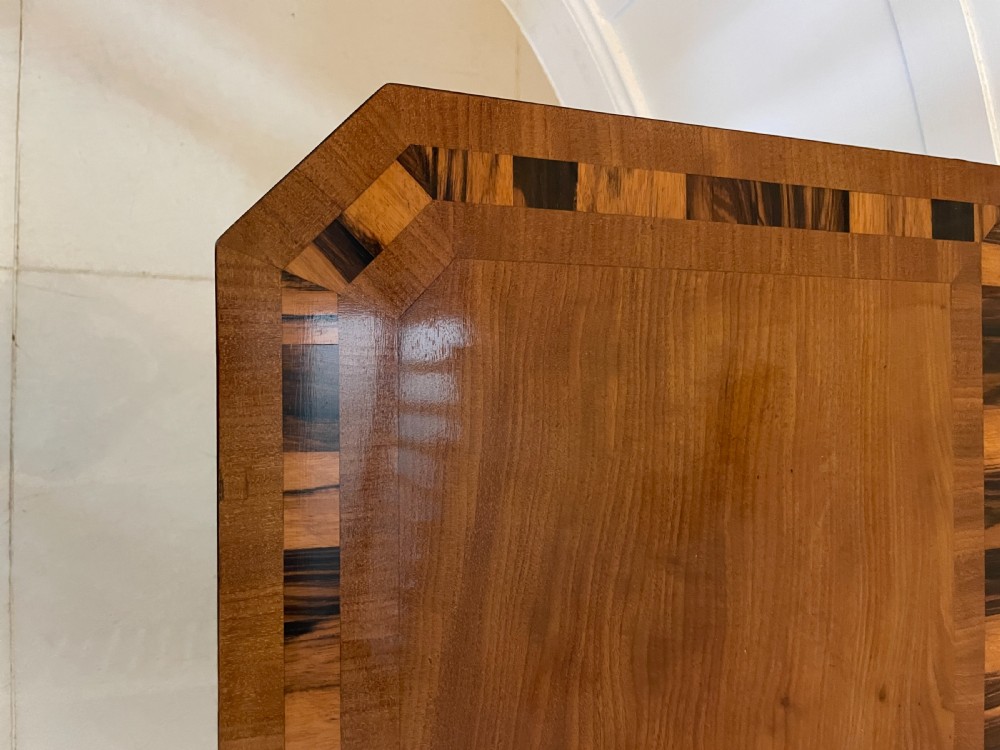 A Regency mahogany fold-over card table featuring crossbanded inlay, a central pedestal base, and four splayed legs with brass paw castors. View XV