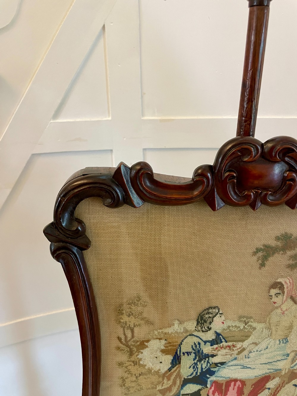 An antique Victorian carved rosewood pole screen featuring a framed tapestry panel depicting a pastoral scene, mounted on an adjustable central column with a tripod base. View X