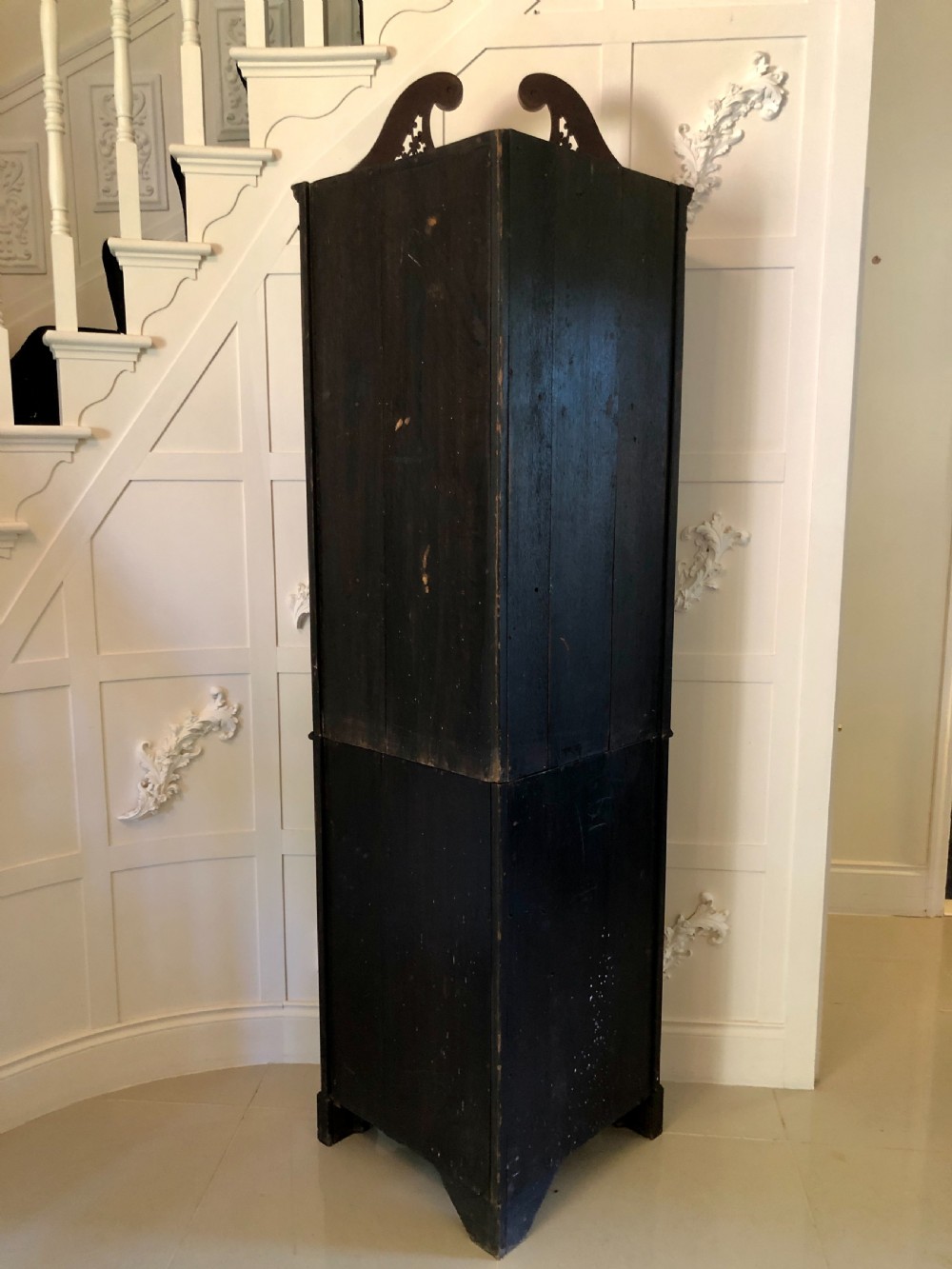 A tall Edwardian mahogany corner cupboard featuring a swan-neck pediment, astragal glazed upper door, and an inlaid lower door with an urn motif. View II