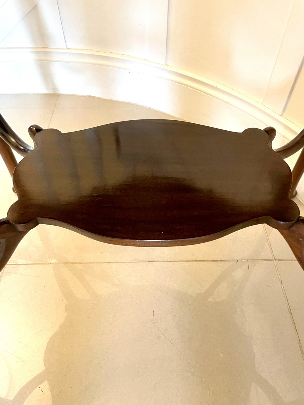 A Victorian mahogany centre table featuring a shaped serpentine top with floral marquetry inlay, slender cabriole legs, and a lower undertier. View III