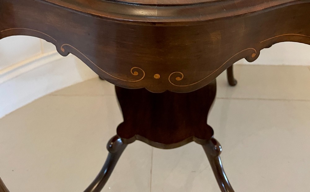 A Victorian mahogany centre table featuring a shaped serpentine top with floral marquetry inlay, slender cabriole legs, and a lower undertier. View IV