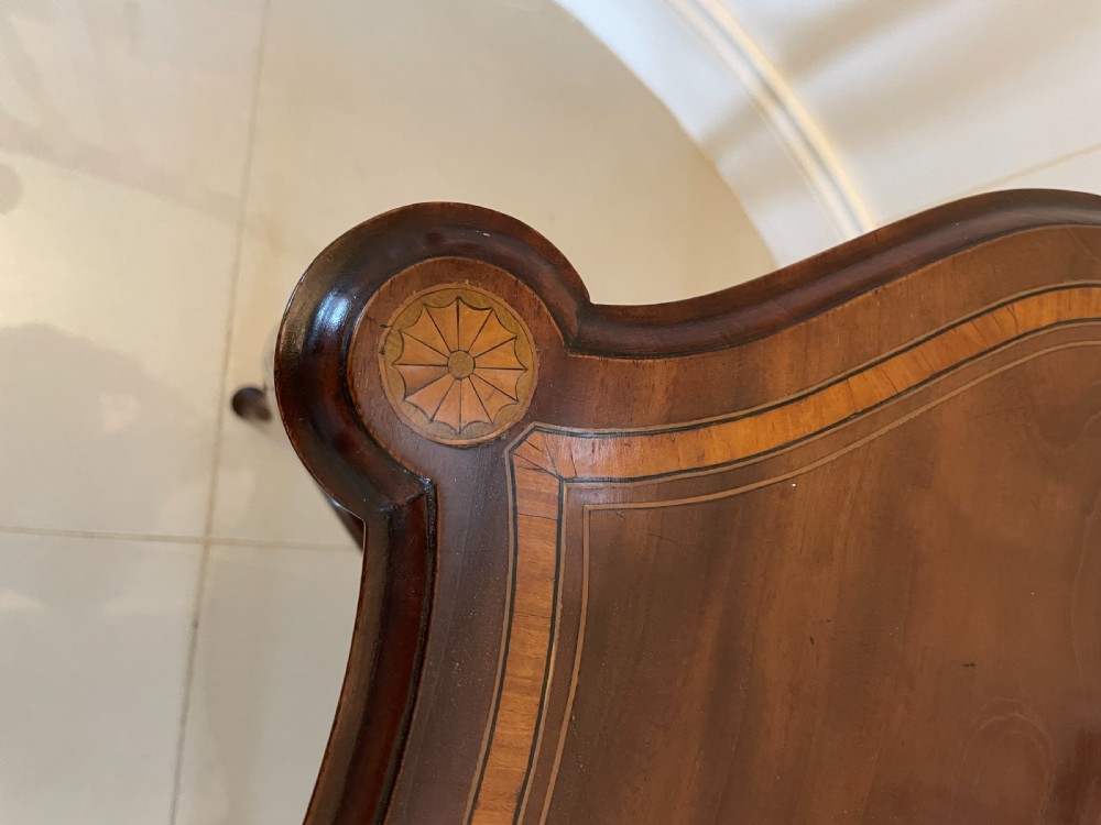 A Victorian mahogany centre table featuring a shaped serpentine top with floral marquetry inlay, slender cabriole legs, and a lower undertier. View VIII