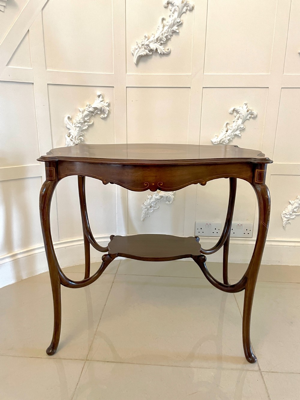 A Victorian mahogany centre table featuring a shaped serpentine top with floral marquetry inlay, slender cabriole legs, and a lower undertier. View XIII