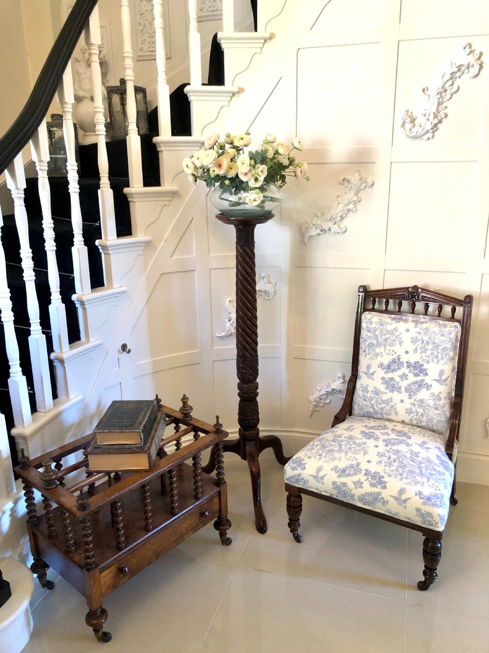 A Victorian carved walnut ladies chair featuring blue and white floral fabric upholstery, turned front legs with castors, and a spindle crest rail. View II