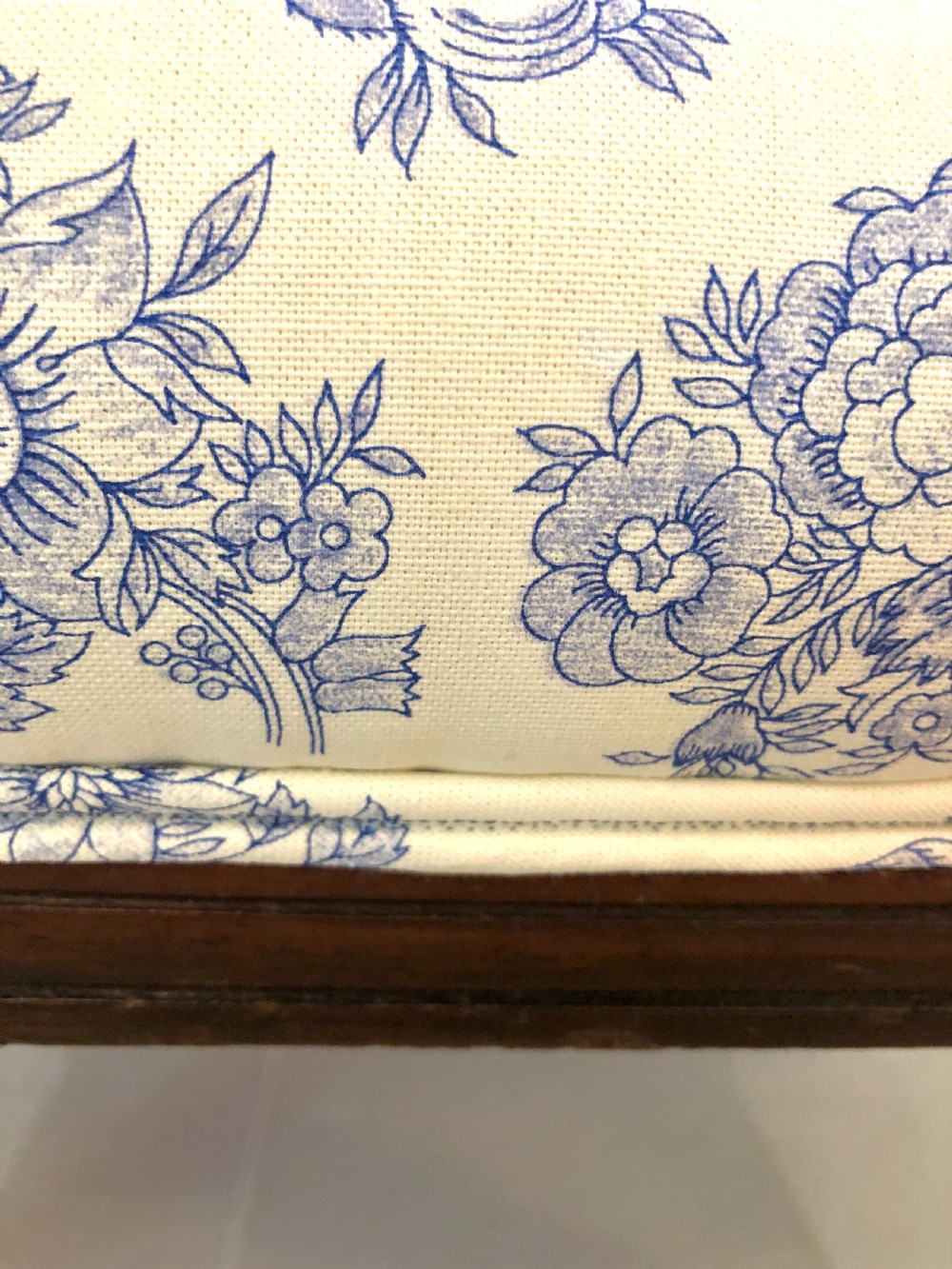 A Victorian carved walnut ladies chair featuring blue and white floral fabric upholstery, turned front legs with castors, and a spindle crest rail. View VI