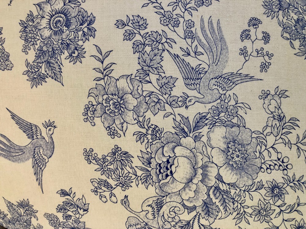A Victorian carved walnut ladies chair featuring blue and white floral fabric upholstery, turned front legs with castors, and a spindle crest rail. View VII