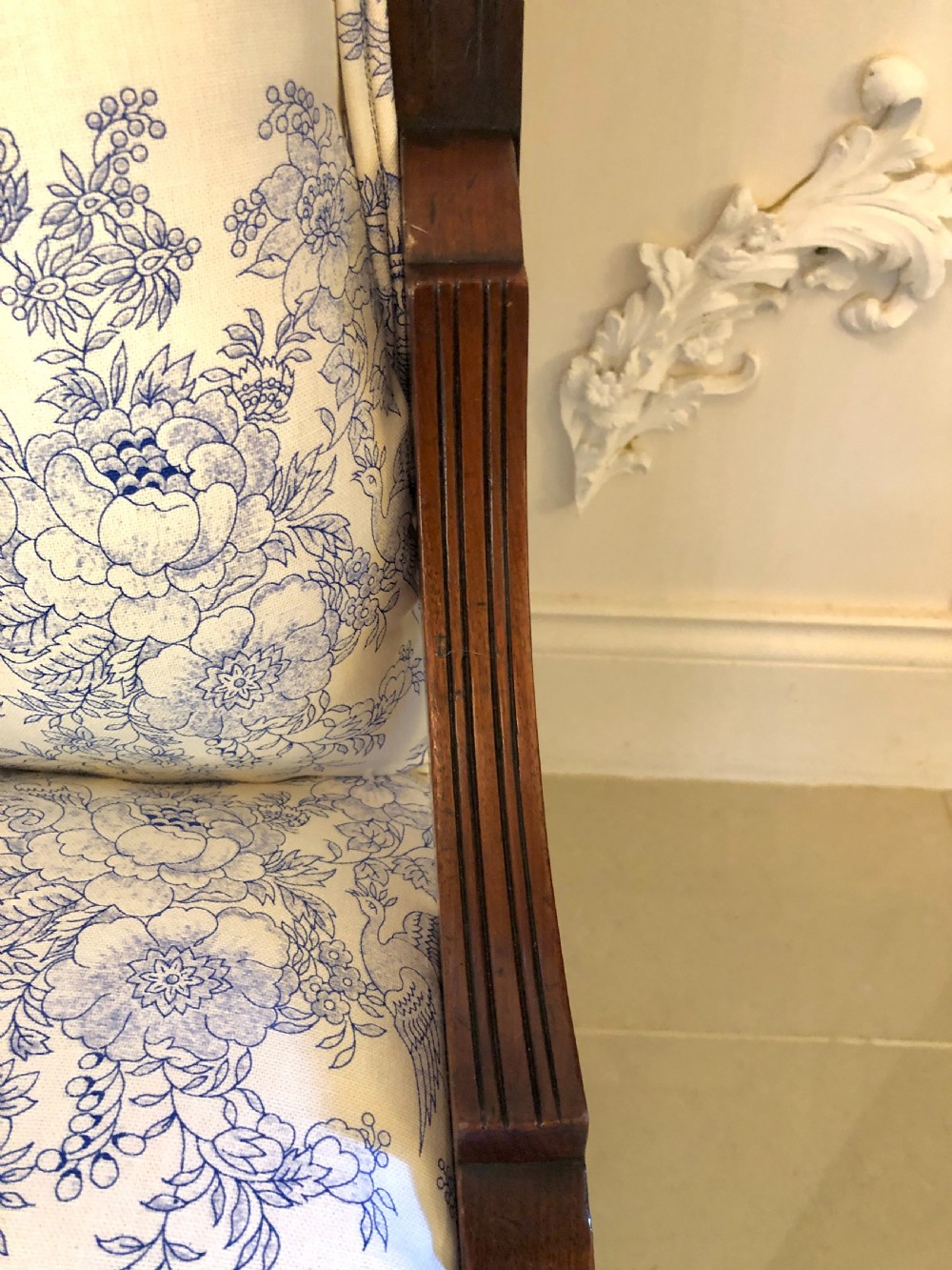 A Victorian carved walnut ladies chair featuring blue and white floral fabric upholstery, turned front legs with castors, and a spindle crest rail. View VIII