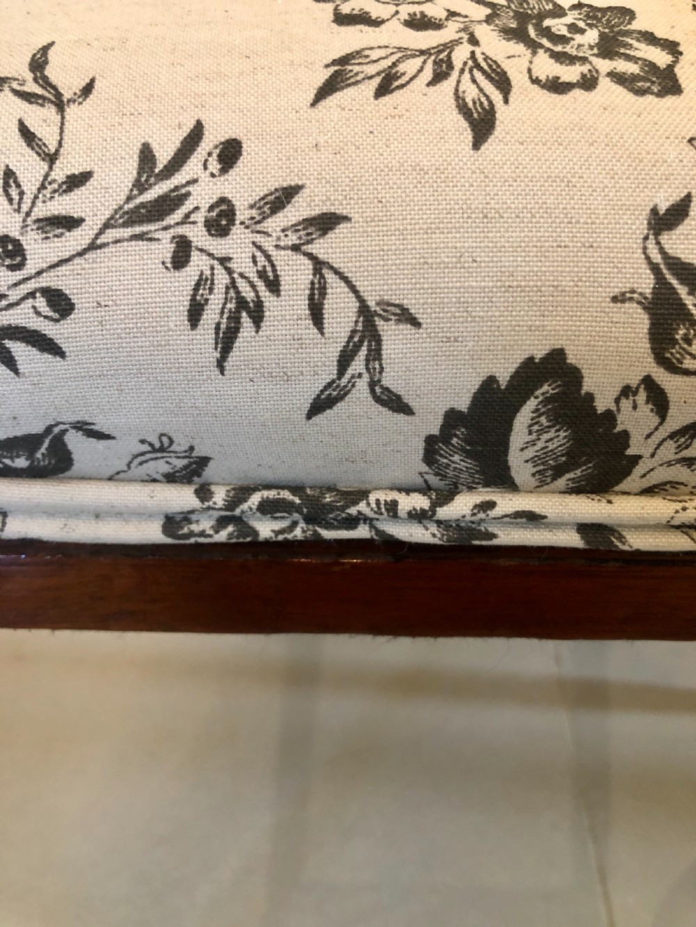 A set of four dark mahogany Victorian dining chairs featuring openwork carved back splats, cabriole front legs, and seats upholstered in a monochrome floral fabric. View VII