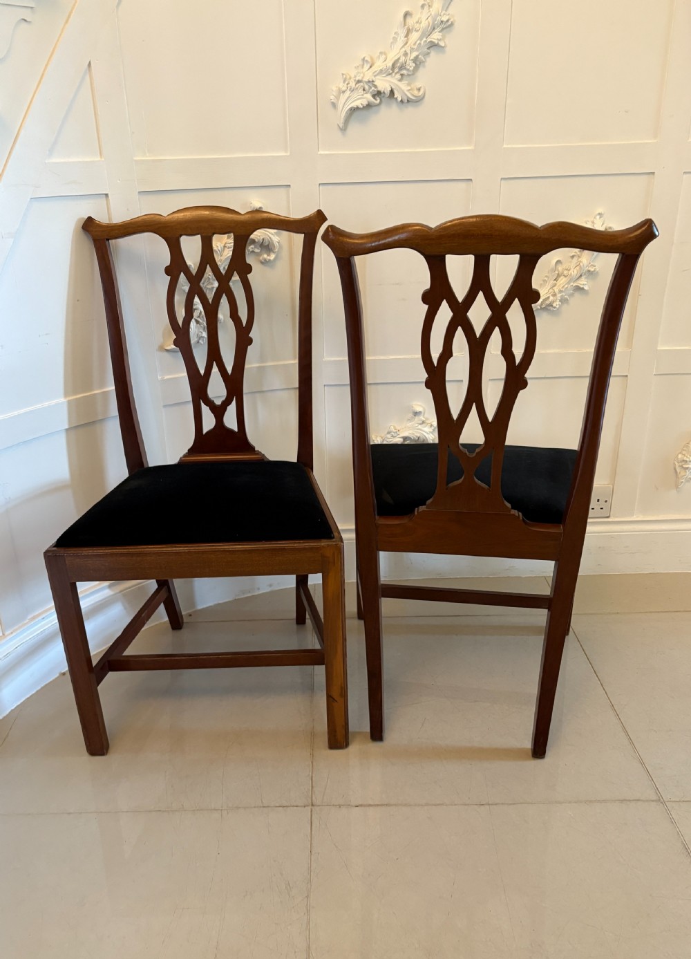 A set of eight Edwardian mahogany dining chairs with carved ribbon-pierced splats and black upholstered drop-in seats, including two armchairs. View XIII